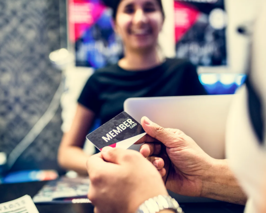 person shopping with their membership pricing card
